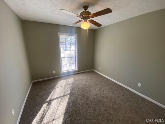 carpeted empty room featuring a textured ceiling and ceiling fan