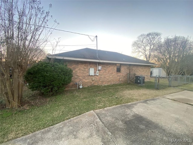 view of home's exterior featuring a yard and central AC unit