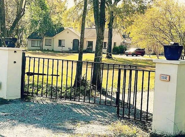 view of gate featuring a yard