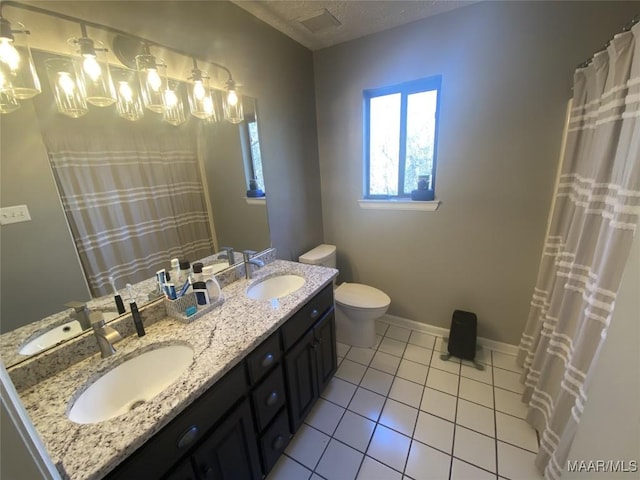 bathroom with tile patterned floors, vanity, and toilet