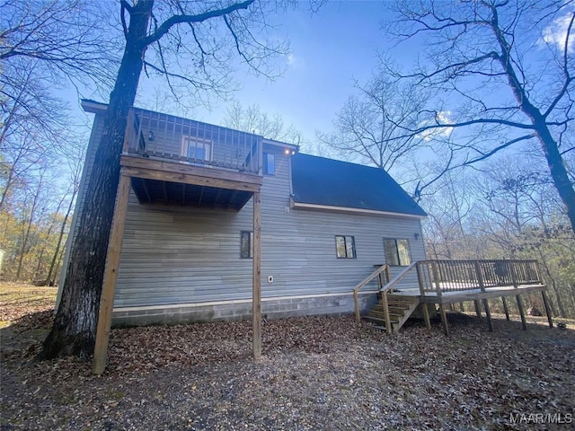 back of house featuring a wooden deck