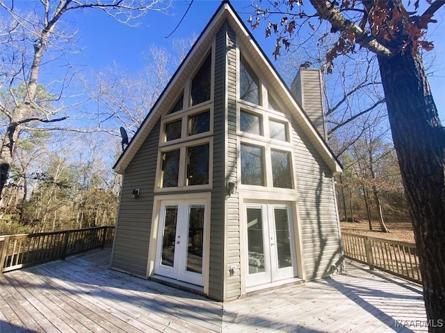 rear view of house with french doors and a deck