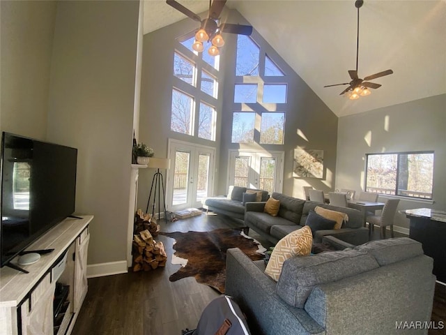 living room featuring high vaulted ceiling, a wealth of natural light, dark wood-type flooring, and ceiling fan