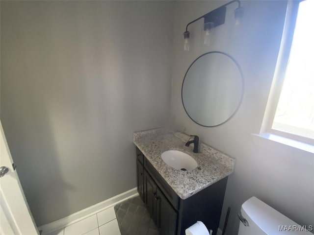 bathroom featuring tile patterned floors, vanity, and toilet