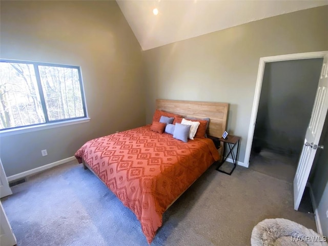 carpeted bedroom with vaulted ceiling