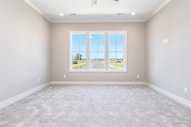 carpeted empty room featuring ceiling fan and crown molding