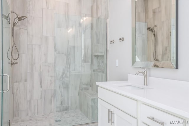 bathroom with a shower with door and vanity