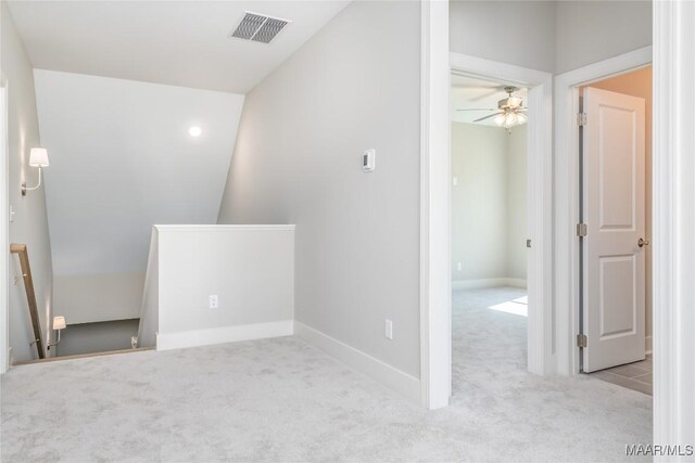 unfurnished room with ceiling fan, light colored carpet, and lofted ceiling