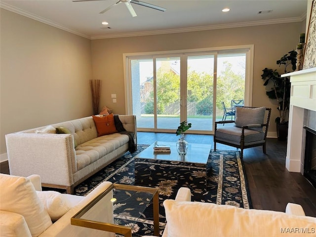 living room featuring ceiling fan, dark wood-type flooring, and ornamental molding