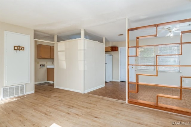 spare room featuring ceiling fan and light wood-type flooring