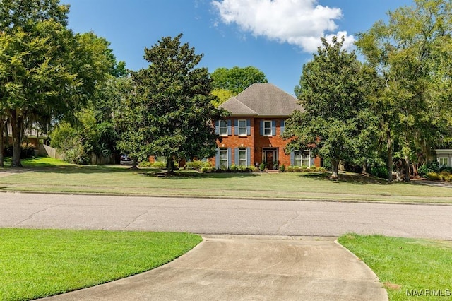 colonial home with a front lawn