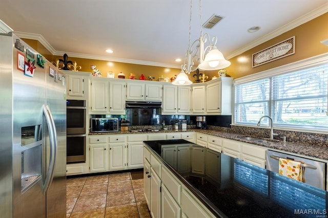 kitchen with decorative backsplash, appliances with stainless steel finishes, white cabinetry, and sink