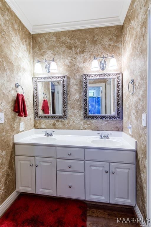 bathroom featuring hardwood / wood-style flooring, vanity, and ornamental molding