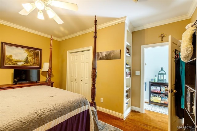 bedroom featuring crown molding, ceiling fan, a closet, and hardwood / wood-style floors