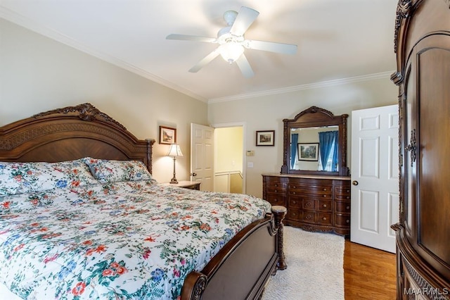 bedroom with light hardwood / wood-style flooring, ceiling fan, and ornamental molding