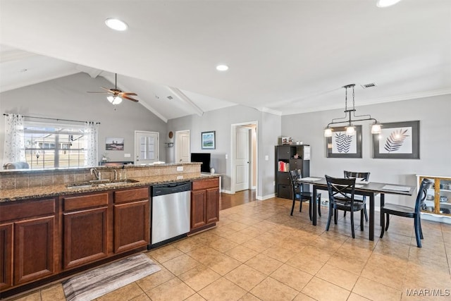 kitchen with ceiling fan, sink, stainless steel dishwasher, pendant lighting, and lofted ceiling