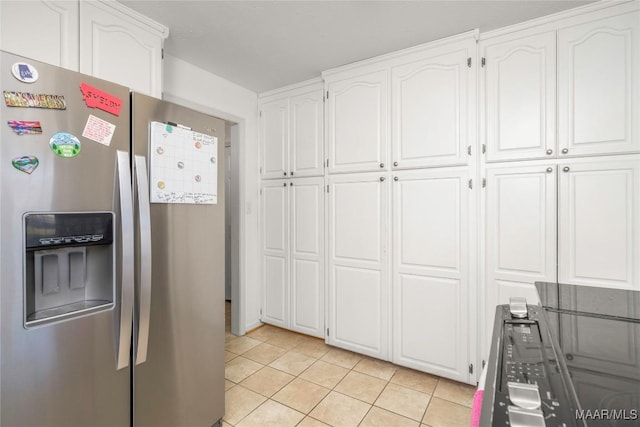 kitchen featuring white cabinetry, light tile patterned floors, and stainless steel refrigerator with ice dispenser