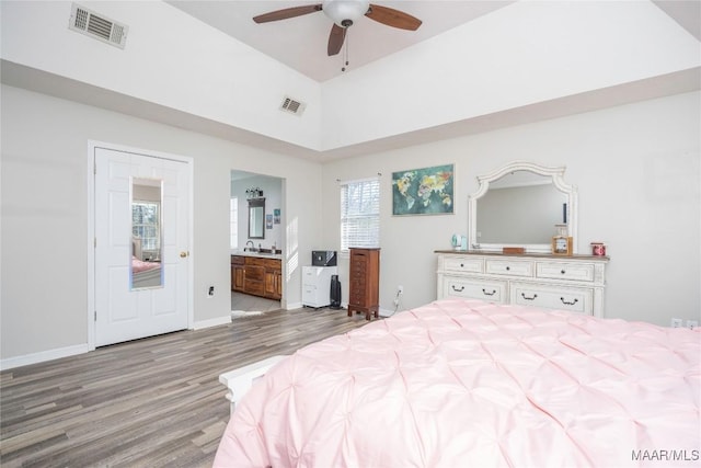 bedroom featuring connected bathroom, ceiling fan, high vaulted ceiling, and light hardwood / wood-style floors