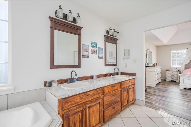 bathroom with a bathing tub and vanity