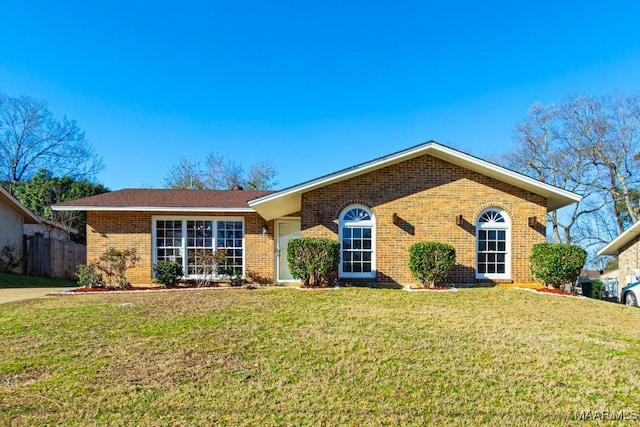 ranch-style home featuring a garage and a front lawn