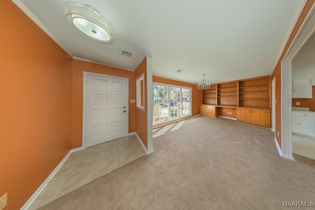 foyer with crown molding, carpet floors, and an inviting chandelier