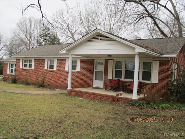 ranch-style home with a front yard and a porch