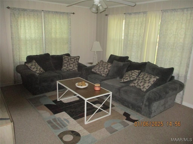 carpeted living room with ceiling fan