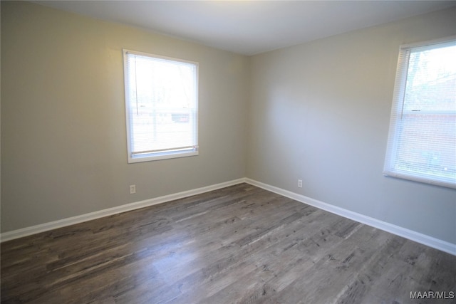 empty room featuring dark hardwood / wood-style floors and plenty of natural light