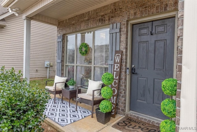 view of exterior entry with covered porch