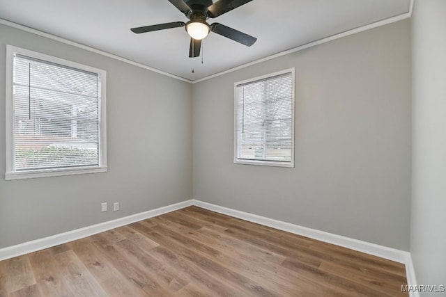 spare room with hardwood / wood-style floors, ceiling fan, ornamental molding, and a wealth of natural light