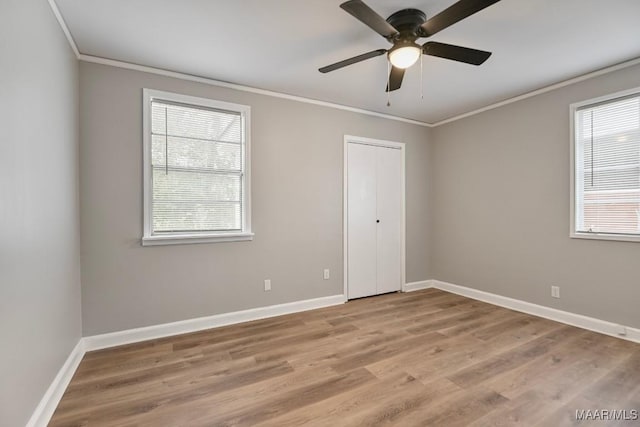 spare room featuring ceiling fan, light hardwood / wood-style flooring, and crown molding