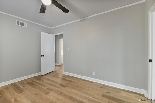 empty room with ceiling fan, light wood-type flooring, and crown molding