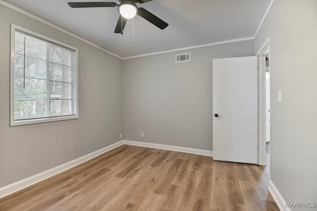 unfurnished room featuring light hardwood / wood-style floors, ceiling fan, and crown molding