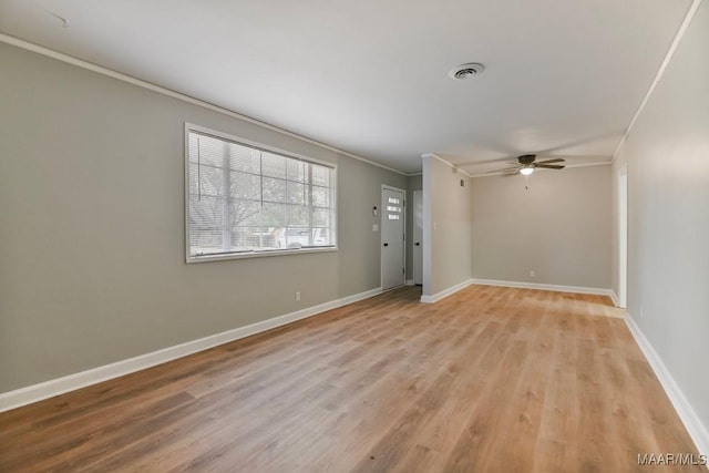 empty room with light wood-type flooring, ceiling fan, and ornamental molding