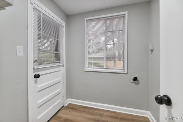 doorway to outside with hardwood / wood-style floors and a healthy amount of sunlight