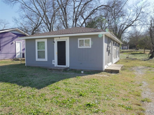 view of front facade with an outbuilding and a front yard