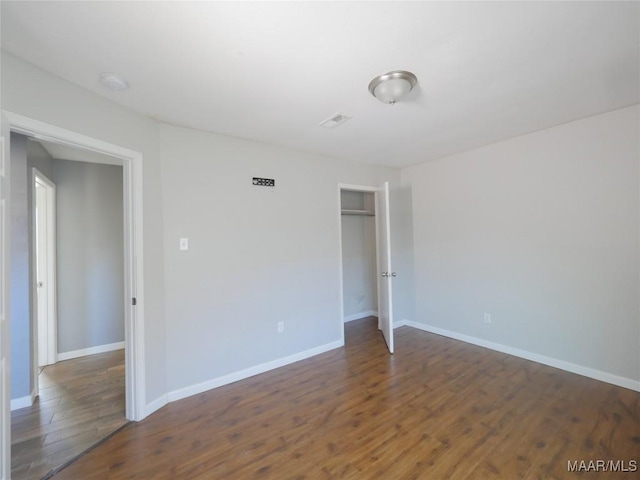 empty room with dark wood-type flooring