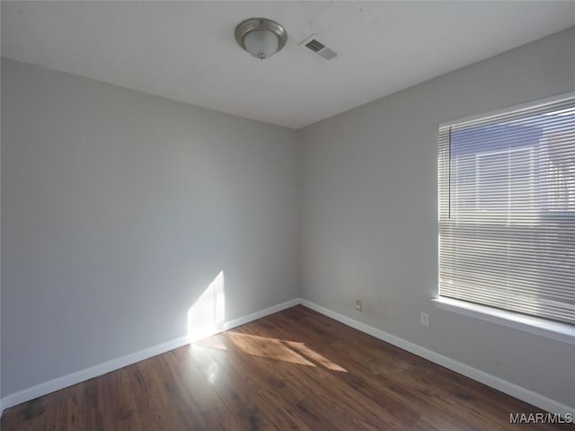 spare room with dark wood-type flooring