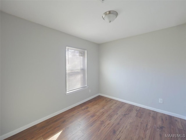 spare room with dark wood-type flooring