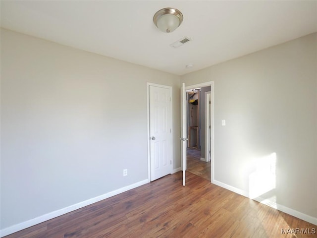 empty room with wood-type flooring