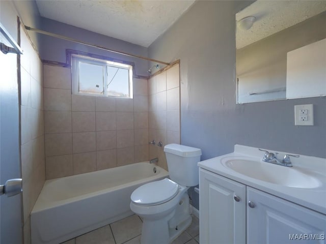 full bathroom featuring a textured ceiling, vanity, tiled shower / bath combo, tile patterned flooring, and toilet