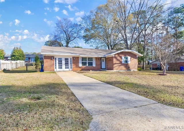 single story home featuring a front yard and french doors