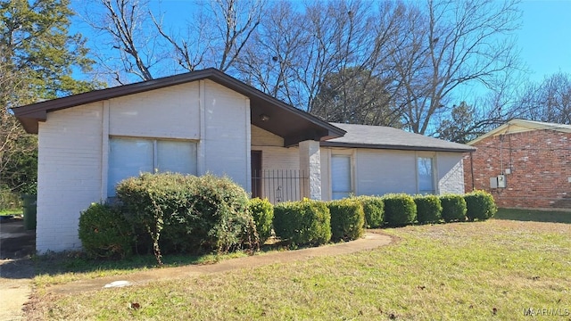 view of side of home featuring a yard