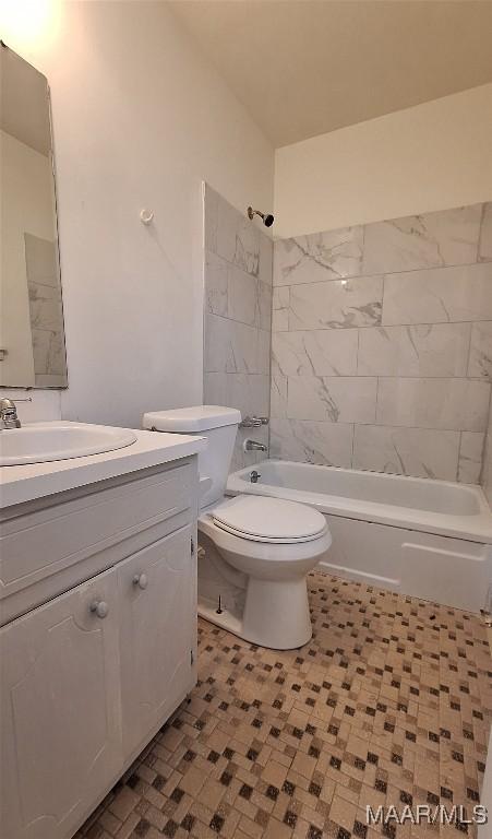 full bathroom featuring vanity, toilet, and tiled shower / bath