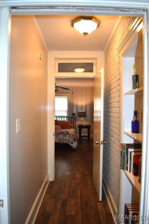 corridor with crown molding and dark hardwood / wood-style floors