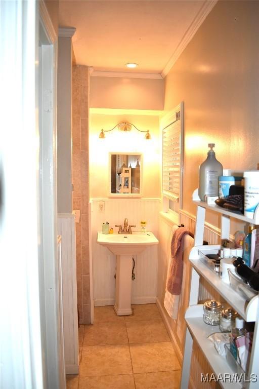 bathroom with tile patterned flooring and crown molding