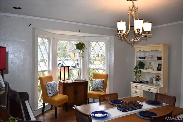 dining area featuring a wealth of natural light, crown molding, and a chandelier