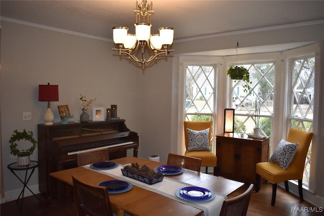 dining room featuring ornamental molding, a notable chandelier, and hardwood / wood-style floors