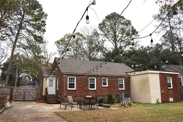 back of house featuring a patio and a lawn