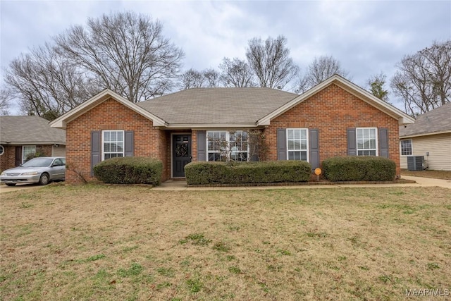 ranch-style house with a front yard and central air condition unit